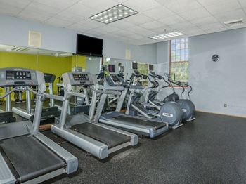 a room filled with cardio equipment and a flat screen tv at Bigelow Commons, Enfield, Connecticut
